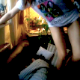 A girl climbs up on a sofa where a person is sleeping and proceeds to fart on his face!